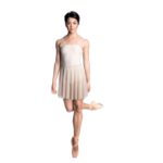 Female dancer standing on pointe on one leg looking at the camera
